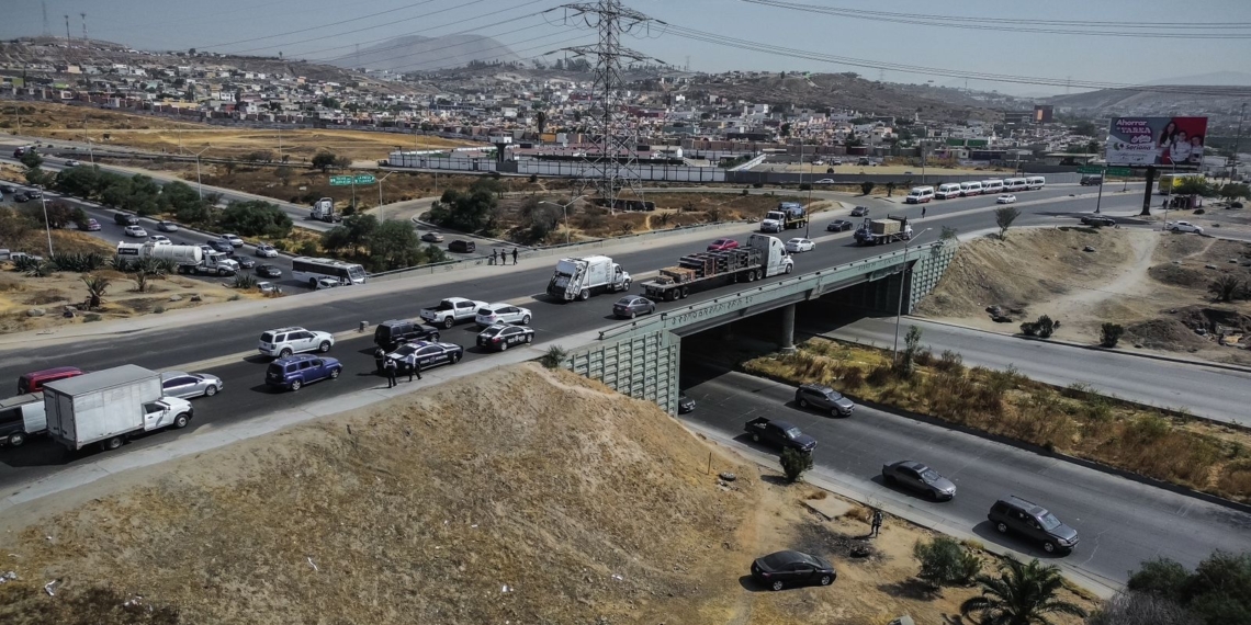 Auto cae de puente vehicular tras ser impactado por un tráiler